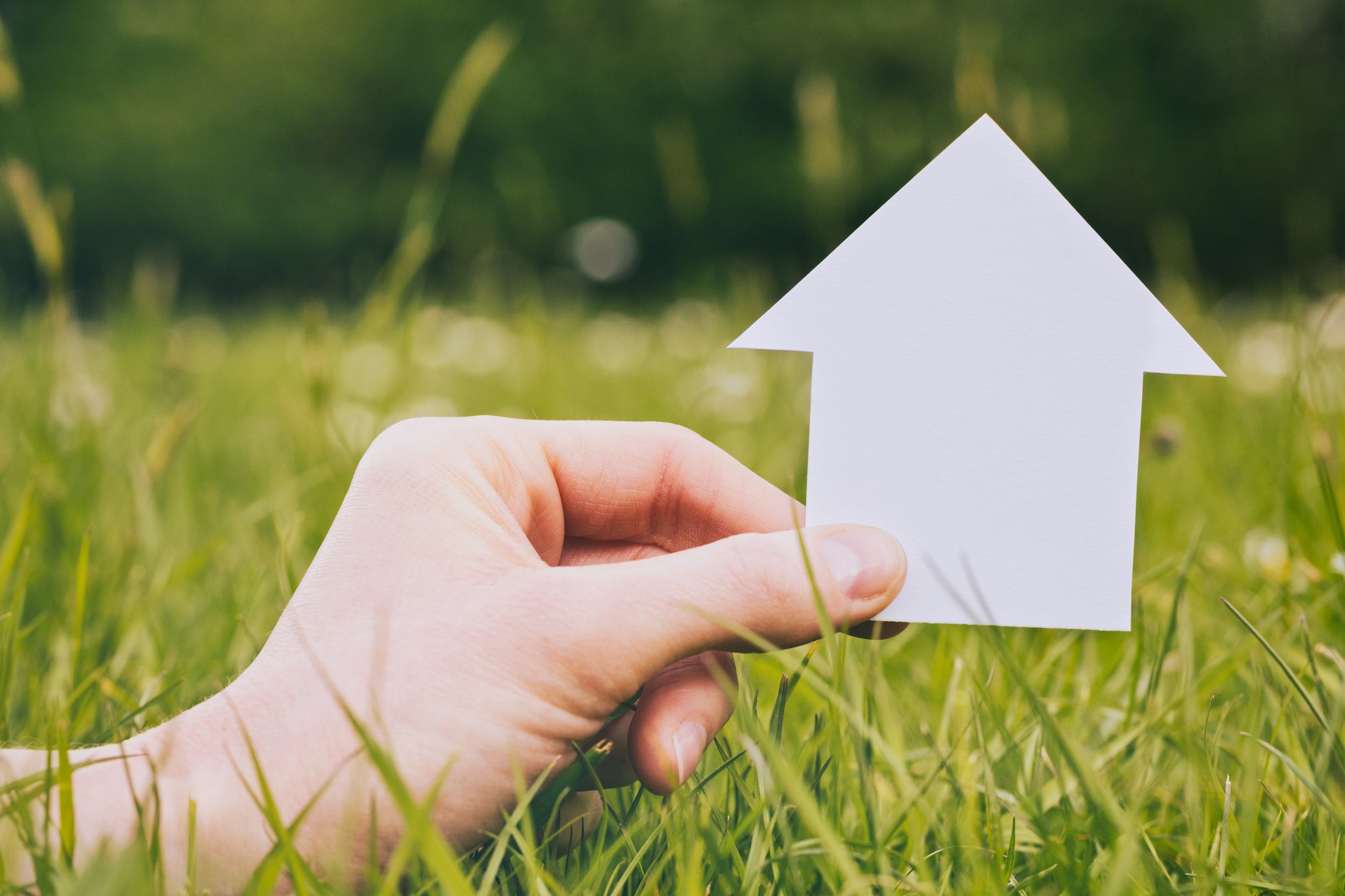 Hand Holding Paper House